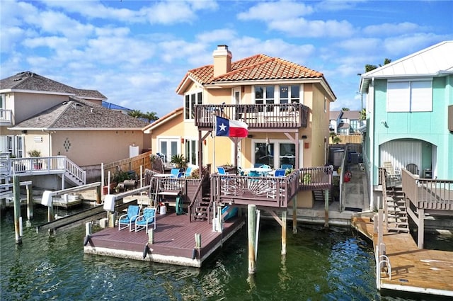 15362 Isabella Ct, Corpus Christi, TX 78418 - rear view of property with a chimney, a balcony, stucco siding, a tiled roof, and a deck with water view