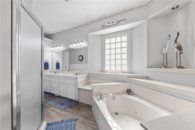 bathroom with separate shower and tub, vanity, and wood-type flooring