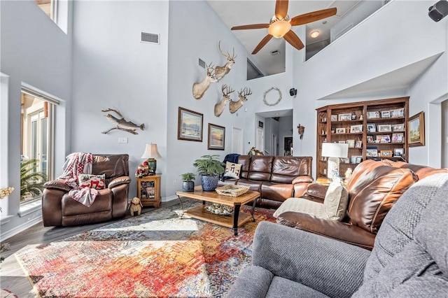 15362 Isabella Ct, Corpus Christi, TX 78418 - living room featuring a towering ceiling, a ceiling fan, healthy amount of natural light, and wood finished floors