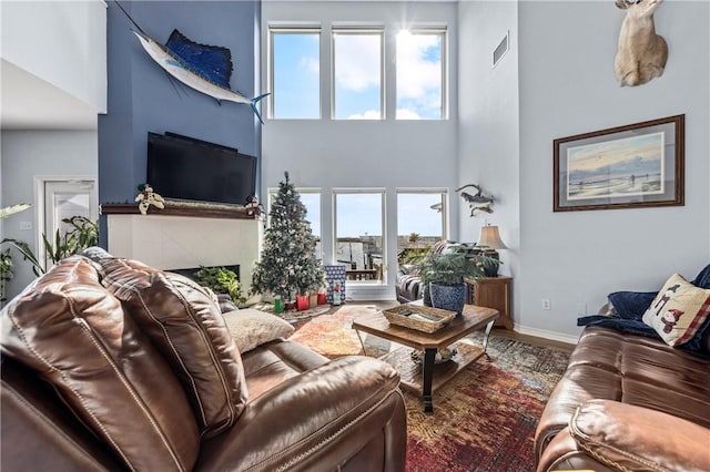 15362 Isabella Ct, Corpus Christi, TX 78418 - living area with a high ceiling, plenty of natural light, wood finished floors, and a fireplace
