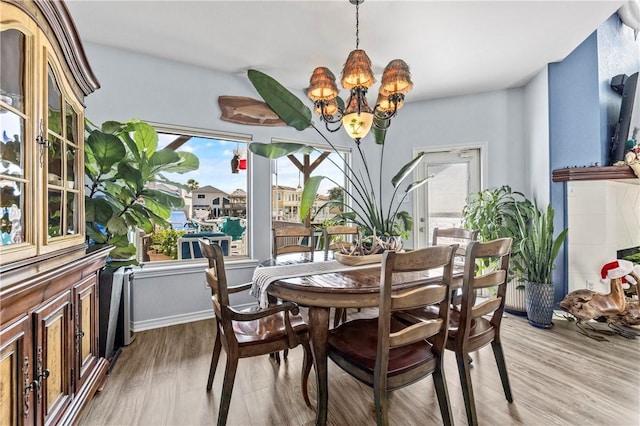 dining room with a chandelier and light hardwood / wood-style flooring