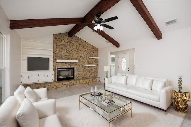 living room with lofted ceiling with beams, hardwood / wood-style flooring, ceiling fan, and a fireplace