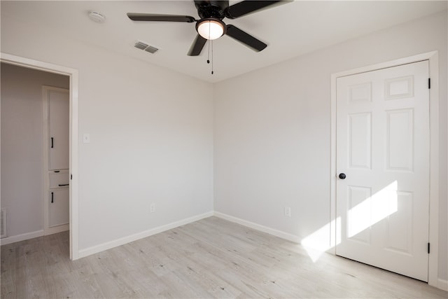 spare room with ceiling fan and light hardwood / wood-style floors