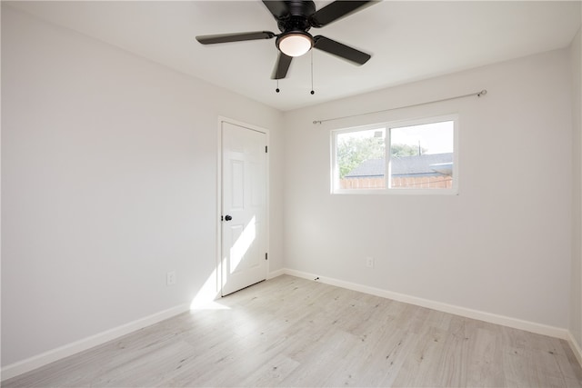 empty room featuring light wood-type flooring and ceiling fan