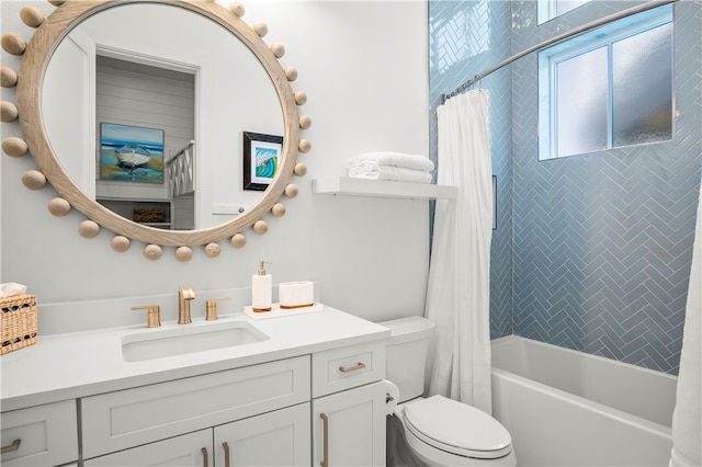 full bathroom featuring vanity, shower / bath combination with curtain, and toilet