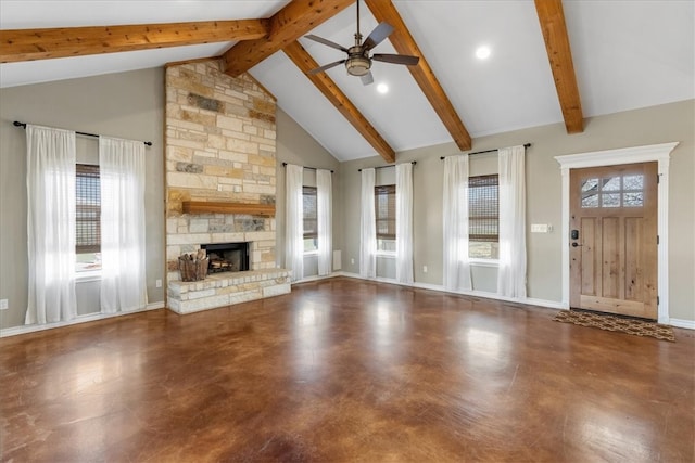 unfurnished living room featuring high vaulted ceiling, a stone fireplace, beam ceiling, and a wealth of natural light