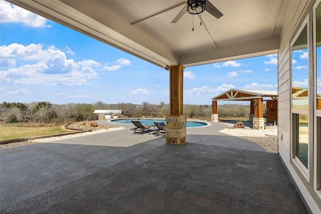 view of patio / terrace with an outdoor pool, ceiling fan, a gazebo, and a jacuzzi