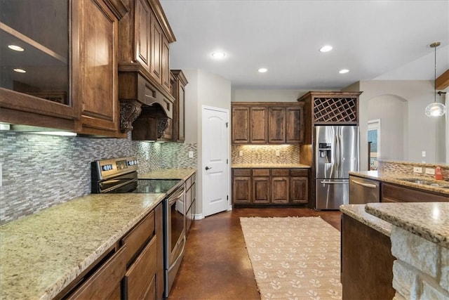 kitchen with light stone counters, recessed lighting, stainless steel appliances, hanging light fixtures, and decorative backsplash