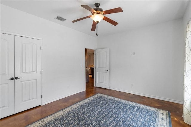 bedroom with baseboards, a closet, visible vents, and finished concrete floors