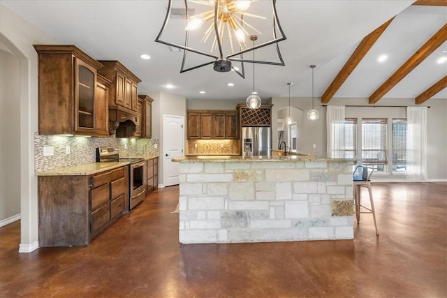 kitchen featuring a breakfast bar area, concrete floors, baseboards, appliances with stainless steel finishes, and backsplash