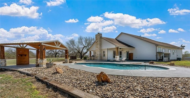 outdoor pool with a patio and a gazebo