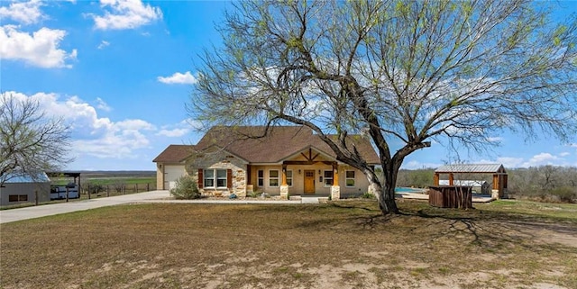 view of front facade with a garage, concrete driveway, and stone siding