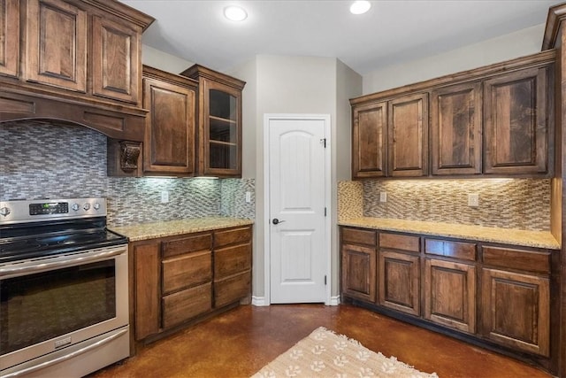 kitchen featuring light stone counters, recessed lighting, backsplash, stainless steel range with electric stovetop, and finished concrete floors