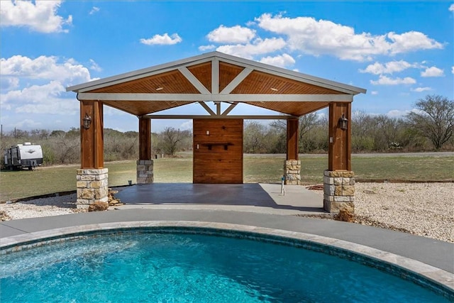 pool with a patio, a lawn, and a gazebo