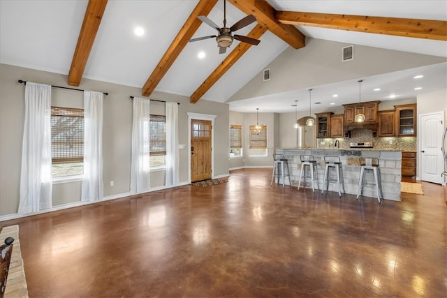 unfurnished living room featuring high vaulted ceiling, baseboards, visible vents, and a ceiling fan