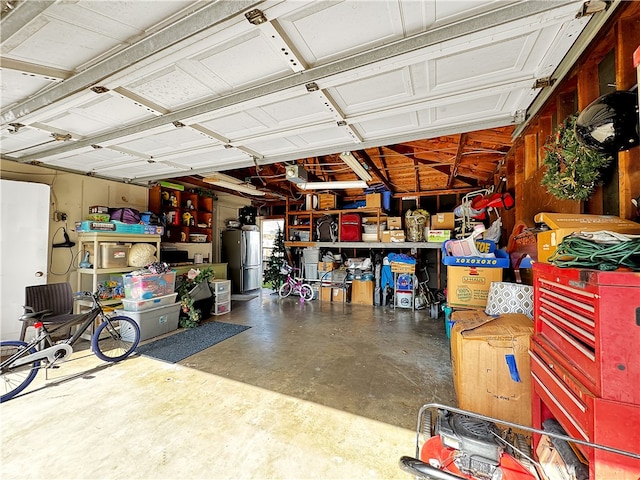 garage with stainless steel refrigerator