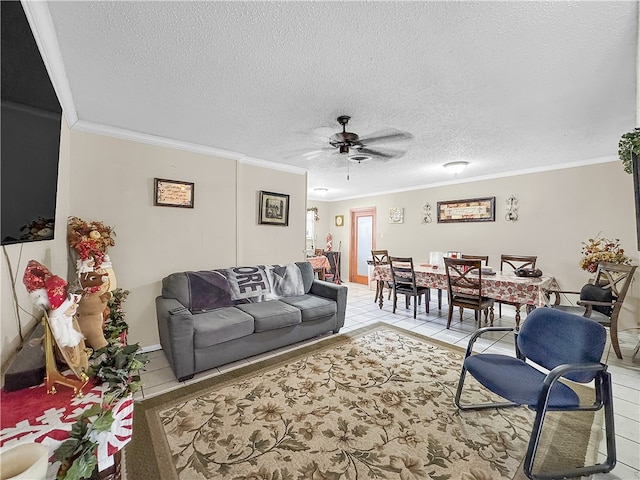 living room with ceiling fan, crown molding, light tile patterned floors, and a textured ceiling