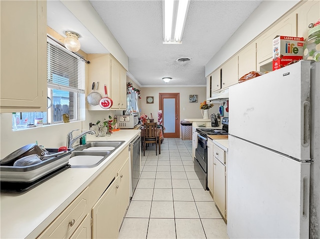 kitchen with ornamental molding, white appliances, sink, light tile patterned floors, and cream cabinetry