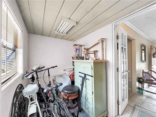 miscellaneous room featuring light tile patterned floors and crown molding