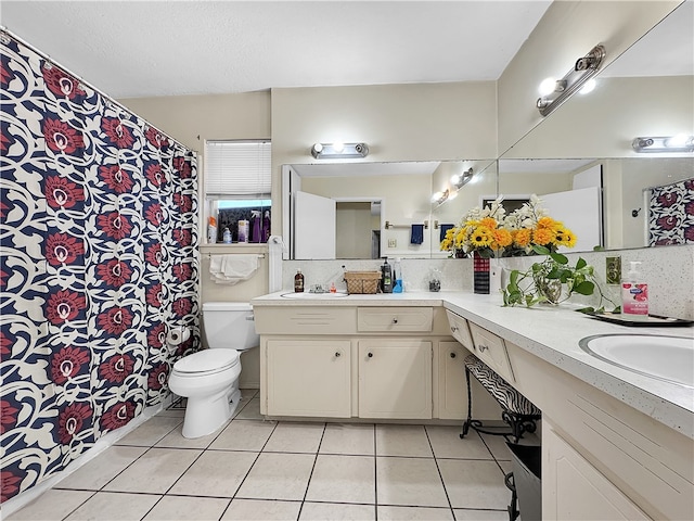 bathroom with tile patterned floors, decorative backsplash, vanity, and toilet