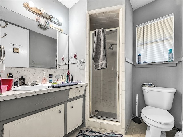 bathroom with vanity, toilet, and an enclosed shower