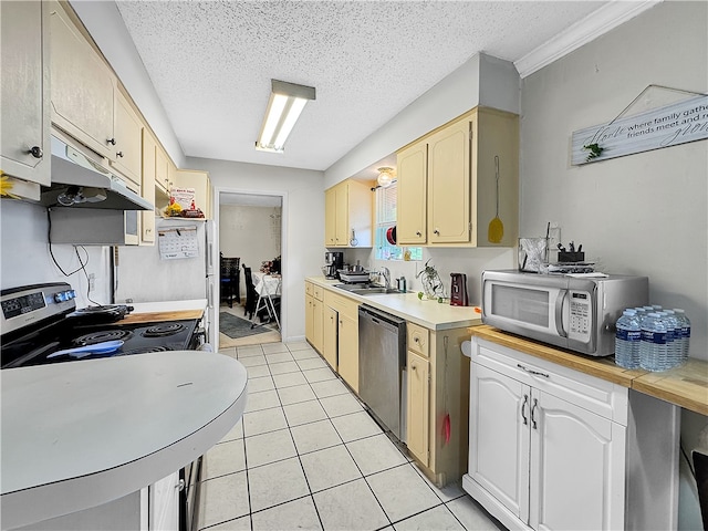 kitchen with a textured ceiling, stainless steel appliances, crown molding, sink, and light tile patterned floors