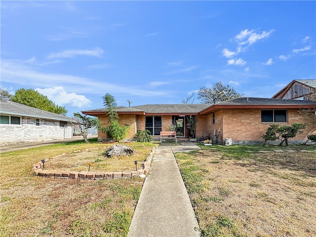 ranch-style house with a front lawn