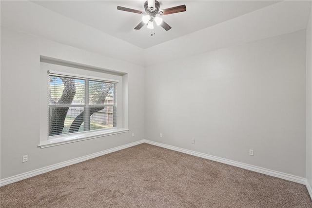 unfurnished room with baseboards, carpet flooring, and a ceiling fan