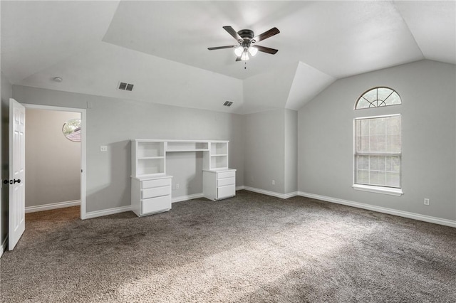 unfurnished bedroom featuring carpet floors, baseboards, visible vents, and lofted ceiling