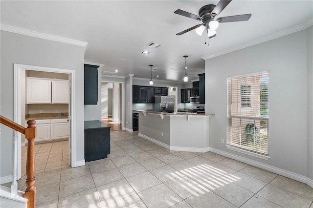 kitchen featuring light tile patterned floors, appliances with stainless steel finishes, ornamental molding, and visible vents