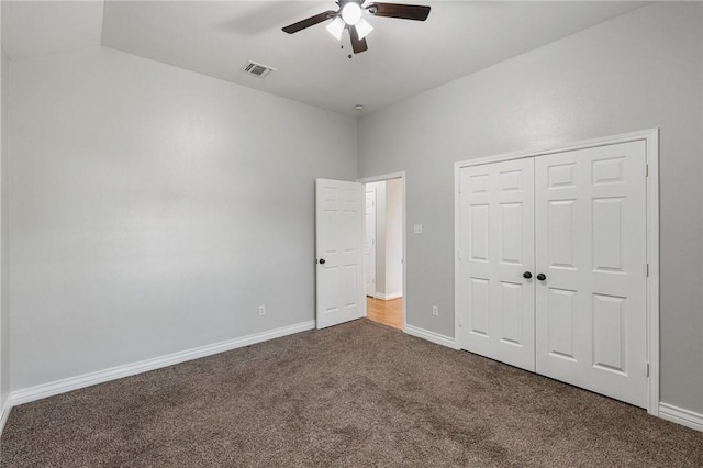 unfurnished bedroom with visible vents, a closet, baseboards, ceiling fan, and carpet flooring
