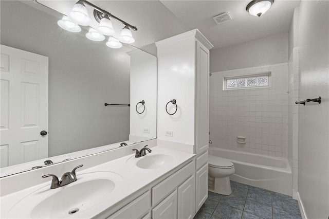 bathroom featuring toilet, tile patterned floors, visible vents, and a sink