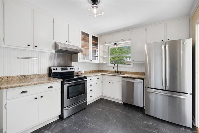 909 Cunningham St, Corpus Christi, TX 78411 - kitchen featuring stainless steel appliances, under cabinet range hood, dark marble finish flooring, a sink, and white cabinetry