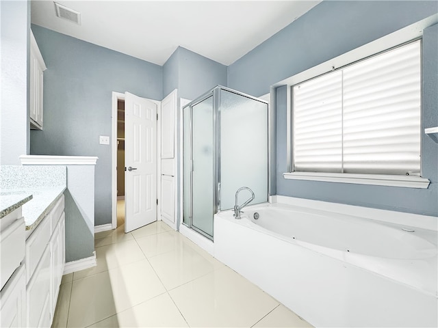 bathroom featuring tile patterned flooring, vanity, and plus walk in shower