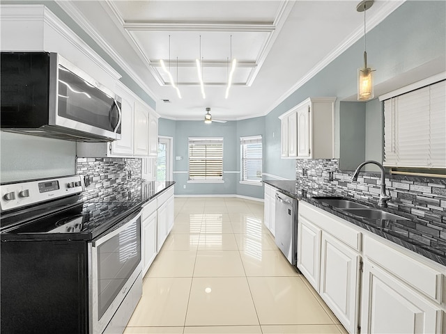 kitchen with white cabinetry, sink, stainless steel appliances, decorative backsplash, and light tile patterned floors