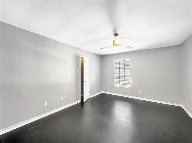 empty room featuring ceiling fan and a textured ceiling