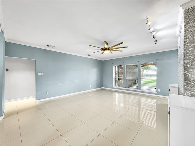 empty room featuring ceiling fan, light tile patterned floors, and crown molding