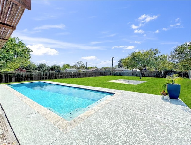 view of swimming pool featuring a yard and a patio