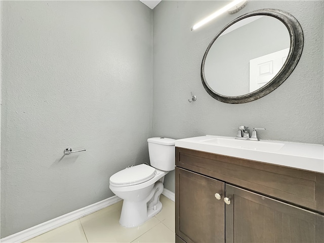 bathroom with tile patterned flooring, vanity, and toilet