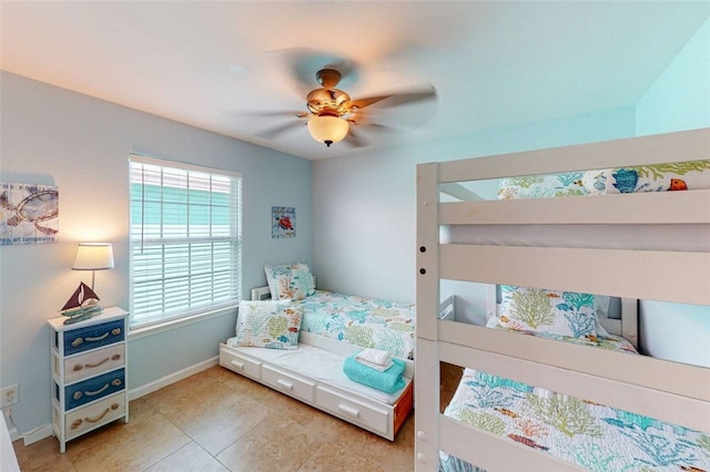 bedroom with ceiling fan and light tile patterned flooring