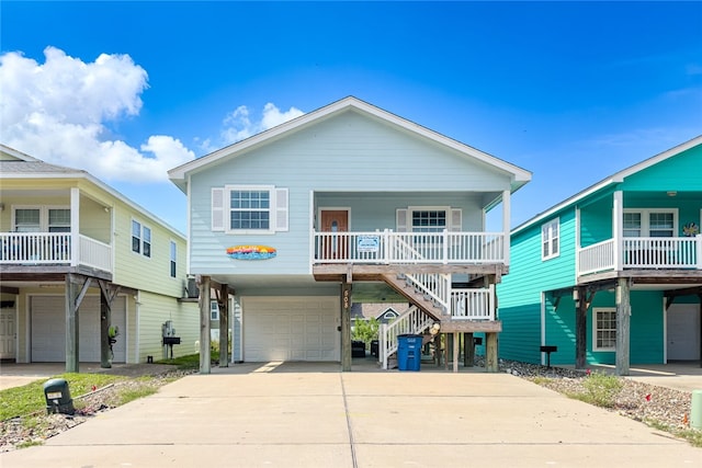 coastal home with a garage, a carport, and covered porch