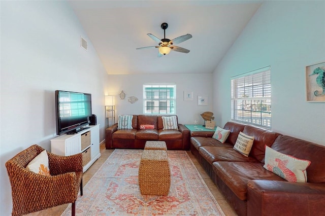 living room featuring ceiling fan and high vaulted ceiling