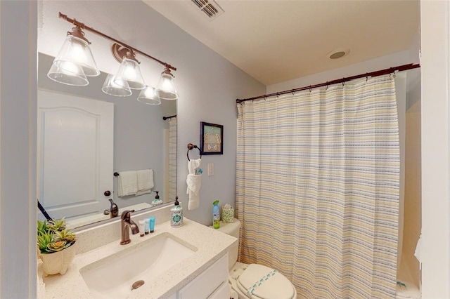 bathroom with vanity, toilet, and walk in shower