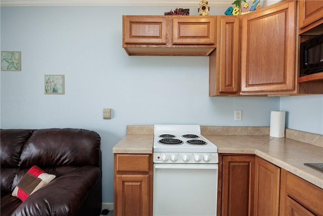 kitchen featuring brown cabinetry, light countertops, white electric stove, and black microwave