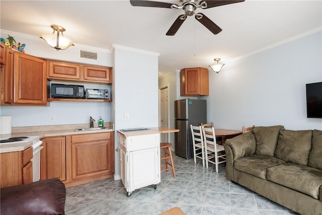 living room with crown molding, a ceiling fan, and visible vents