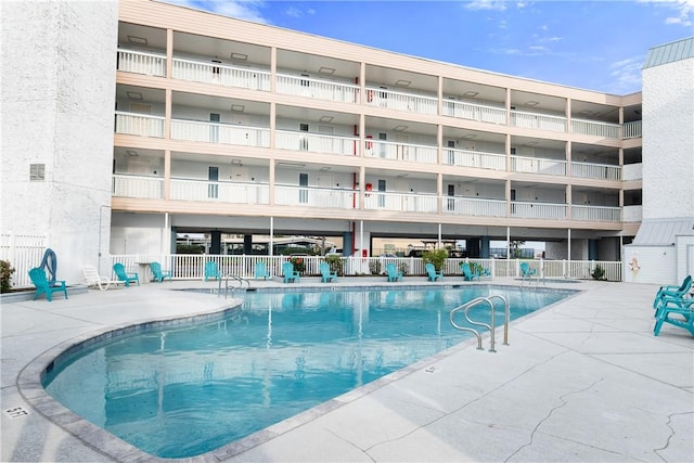 pool featuring a patio and fence
