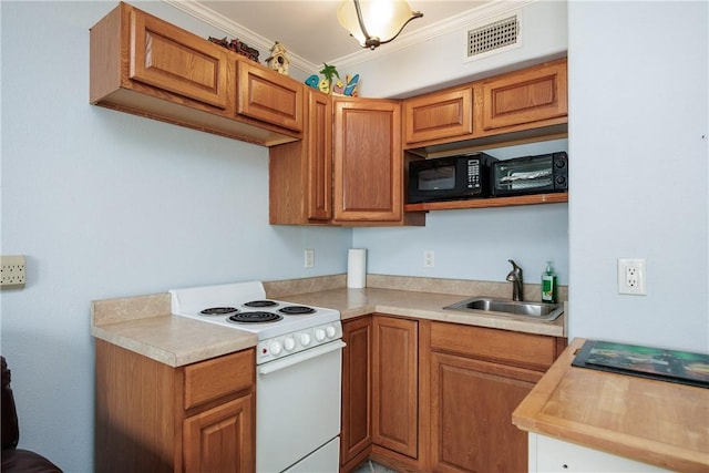 kitchen featuring light countertops, electric range, visible vents, and a sink
