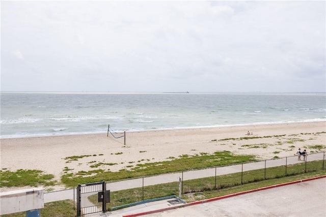 water view with fence and a view of the beach