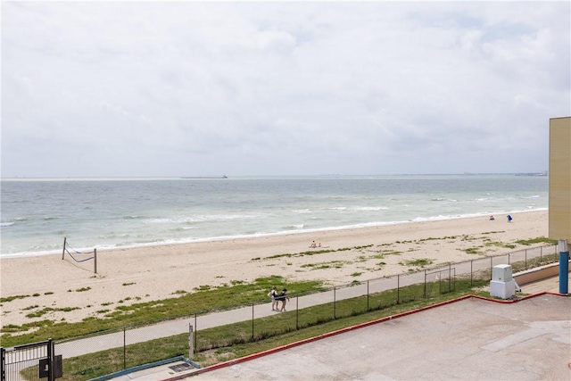 water view with a beach view and fence