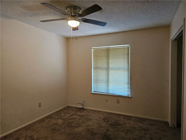 carpeted spare room featuring ceiling fan and a textured ceiling